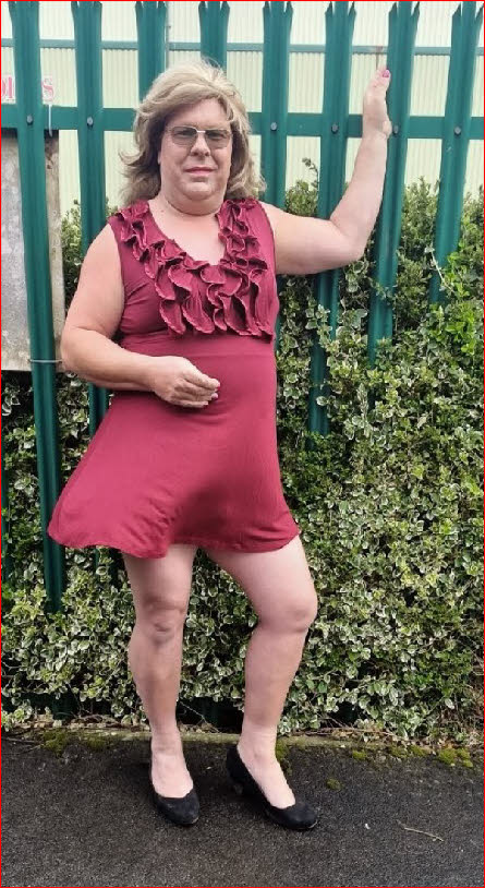 Cross-dressing sissy Rebecca parading outside in a short satin dress