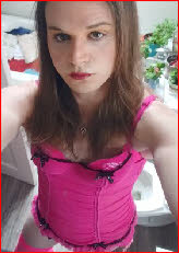 Mincing sissy Candi in pink corset and red lipstick