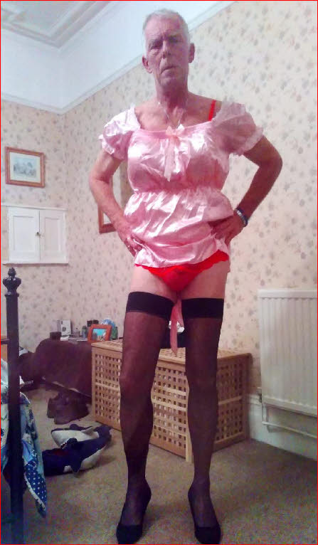 Welsh sissy slut Rachel in pink frilly dress and red knickers