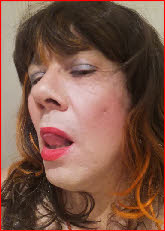Sissy Davina licking her lipstick-covered lips